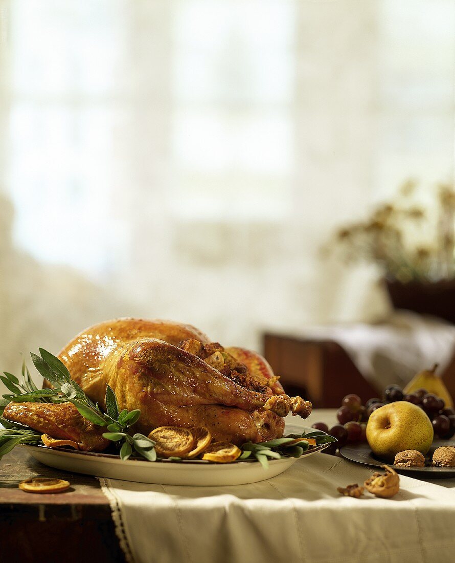 Roast turkey with dried fruit and sage on platter