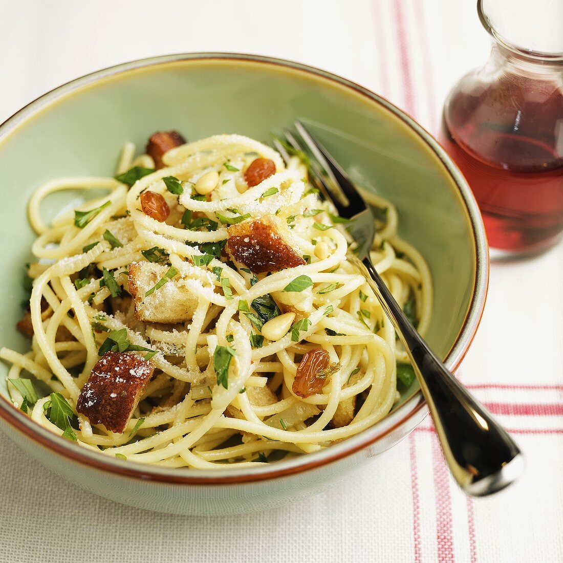 Spaghetti with Raisins and Pine Nuts in a Green Bowl