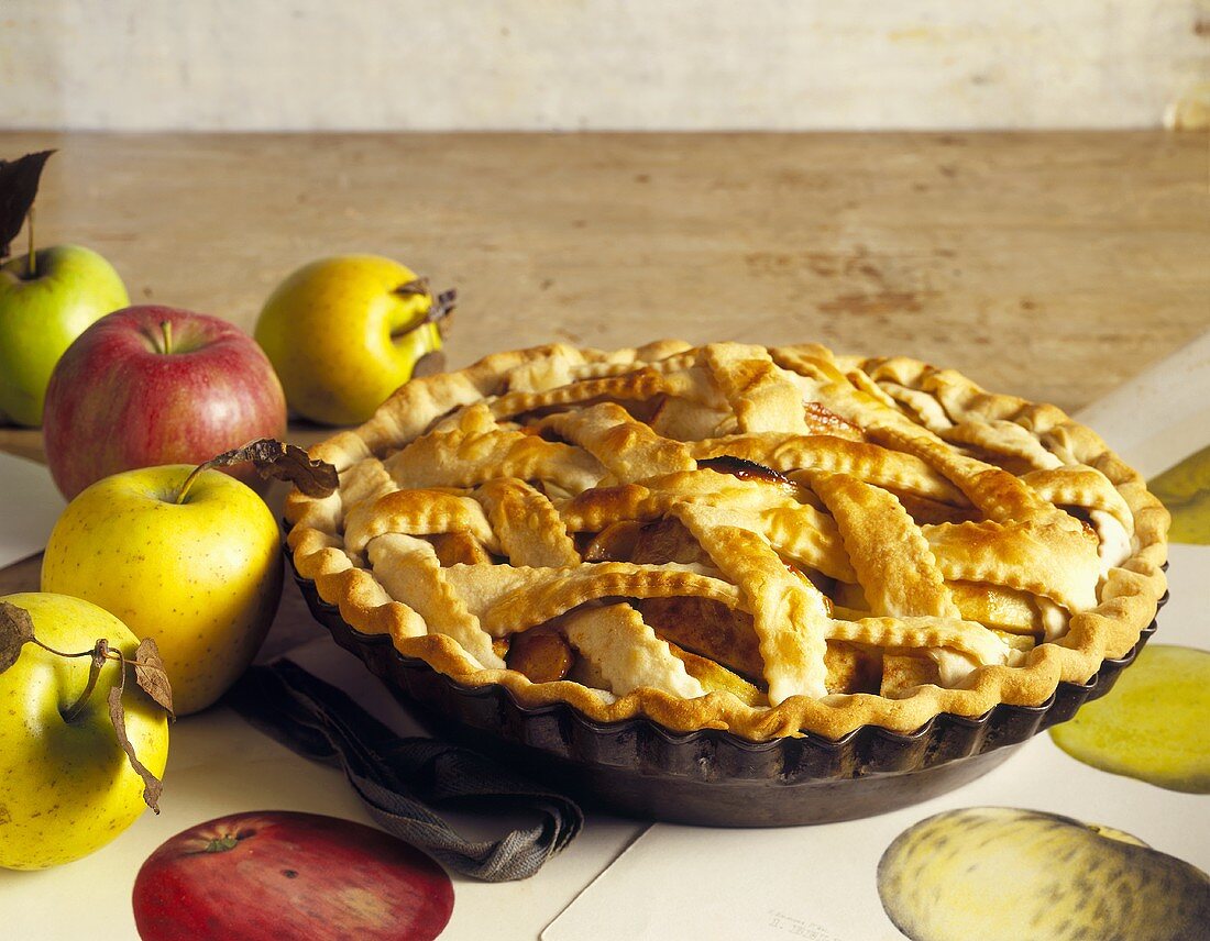 A Whole Apple Pie with a Lattice Crust and Fresh Apples