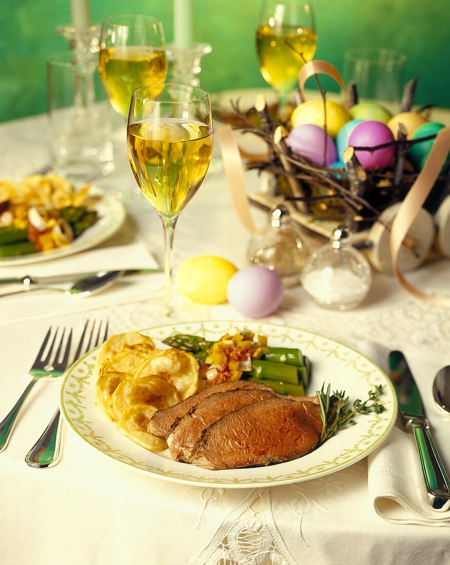 Easter Table Setting with Roast Beef, Potatoes and Asparagus with White Wine
