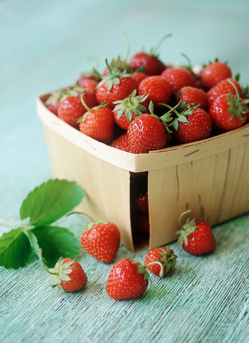 Fresh Strawberries in and Beside a Container