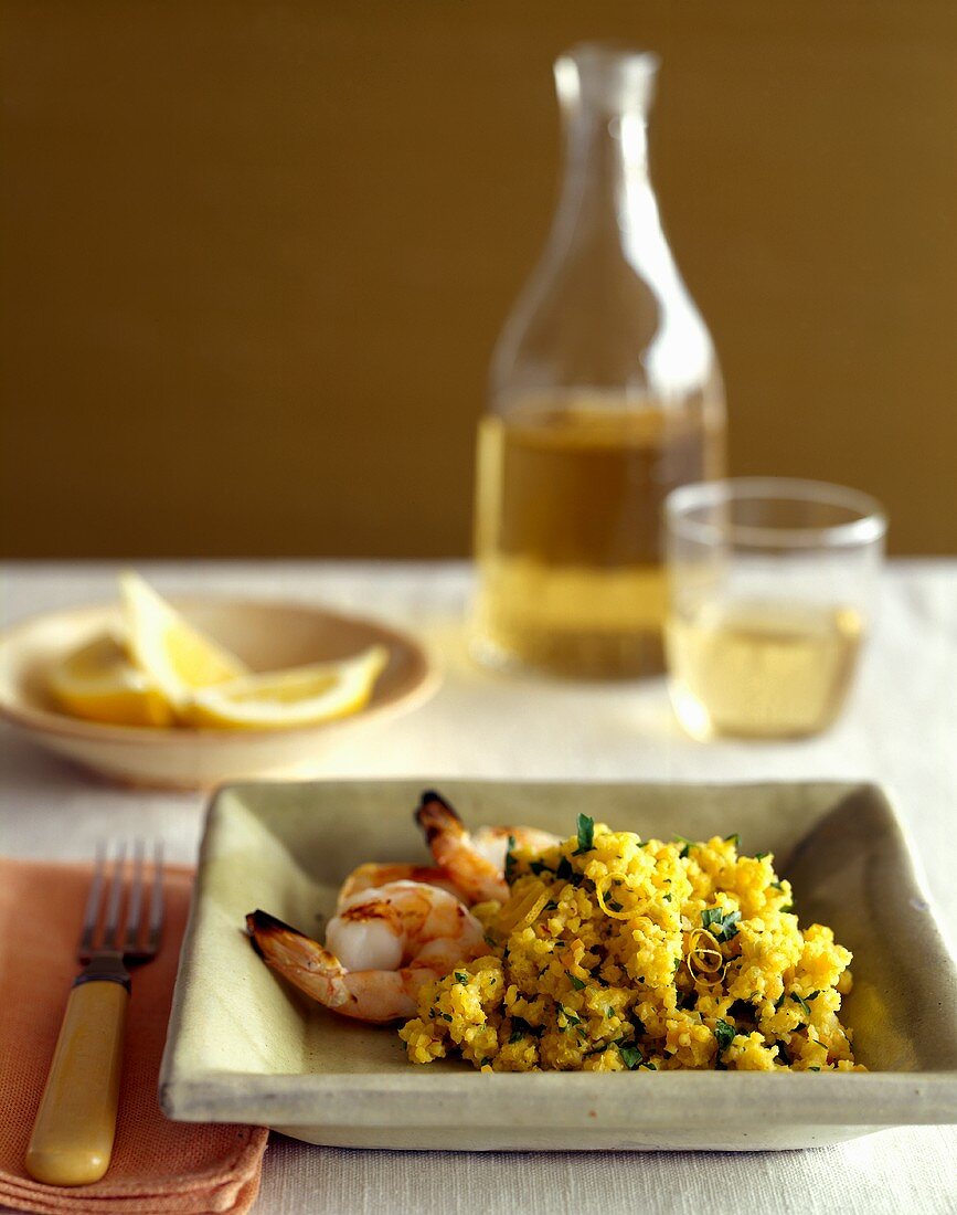 Shrimps with saffron couscous; white wine; lemon wedges