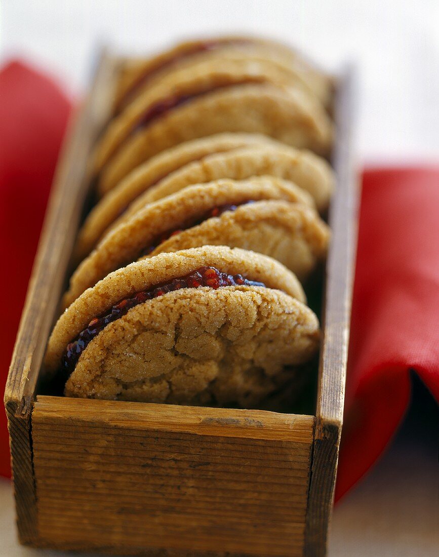 Biscuits filled with raspberry jam in wooden box