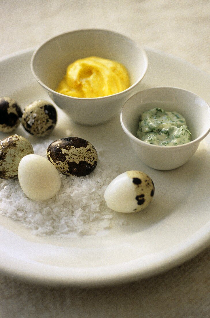 Boiled quail's eggs, partly shelled, with salt and dips