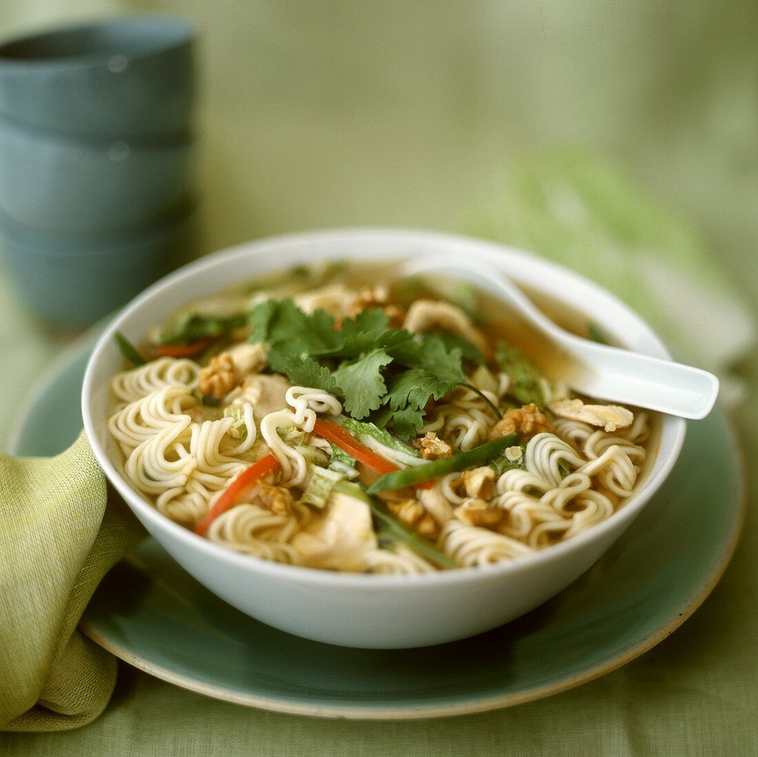 Noodle soup with chicken, nuts and coriander leaves