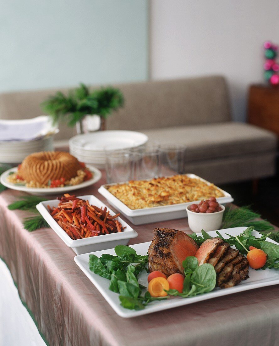Buffet with roast beef and accompaniments in living room