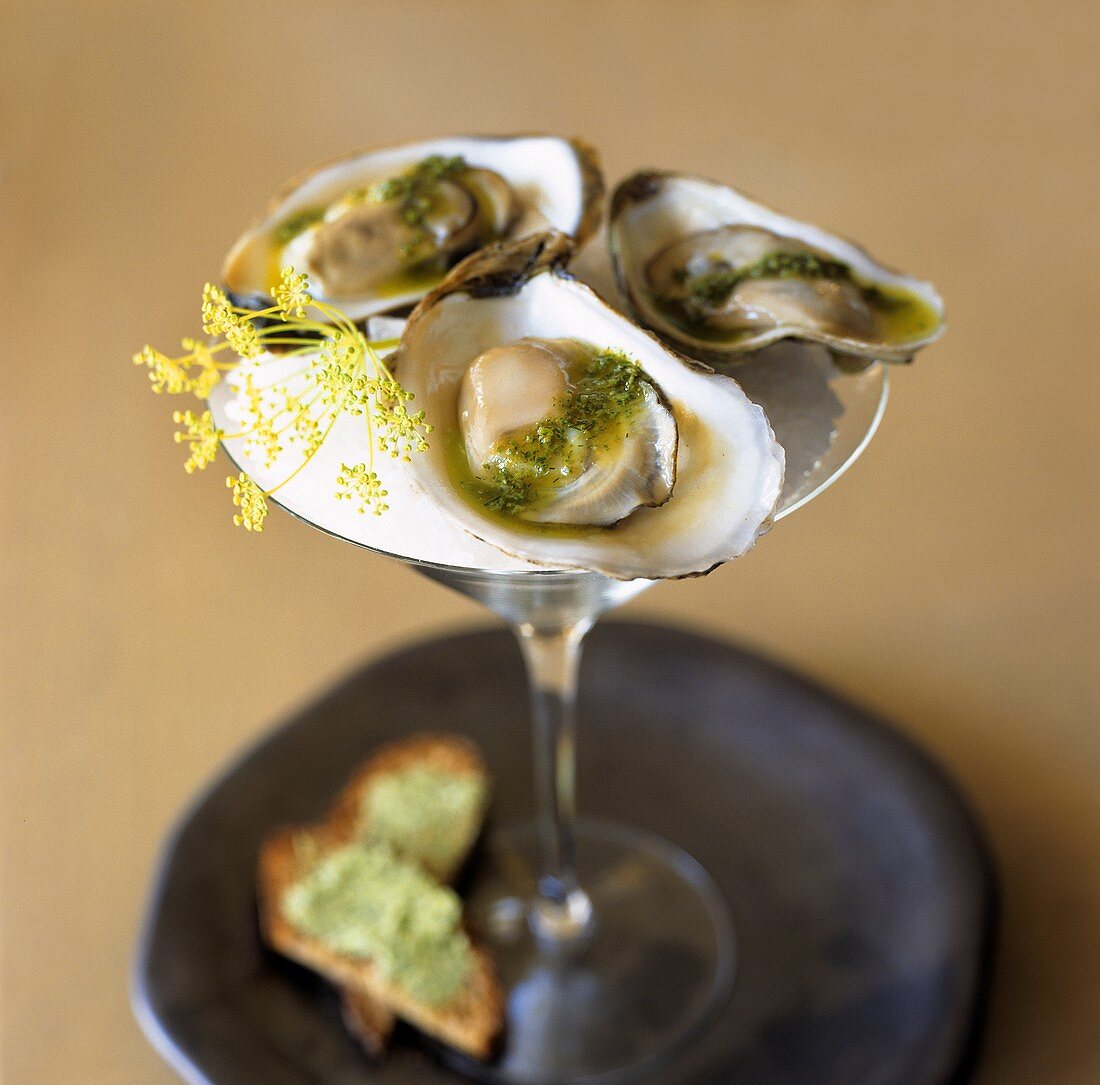 Three oysters with pesto in a Martini glass