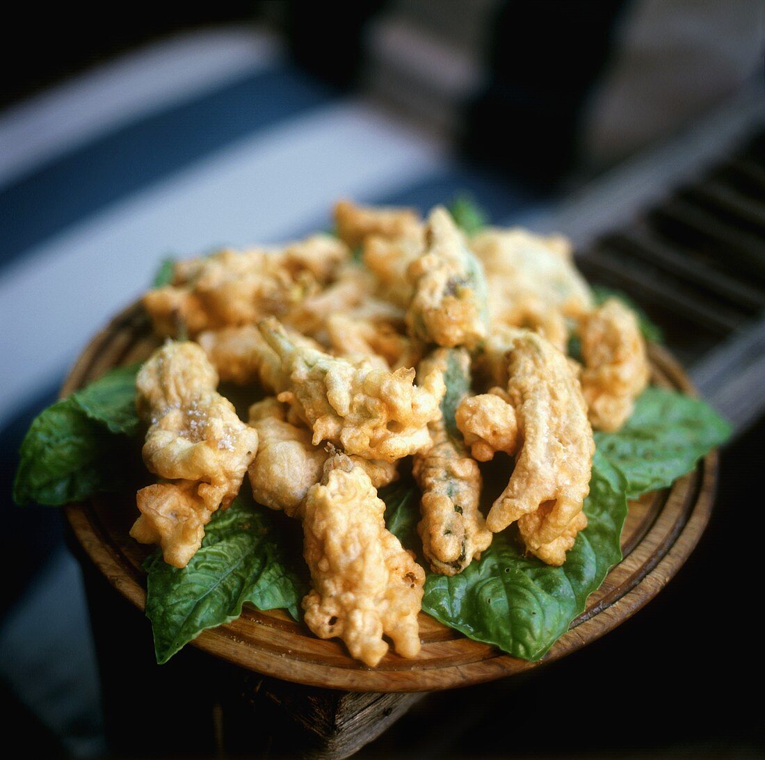 Deep-fried herbs on spinach leaves