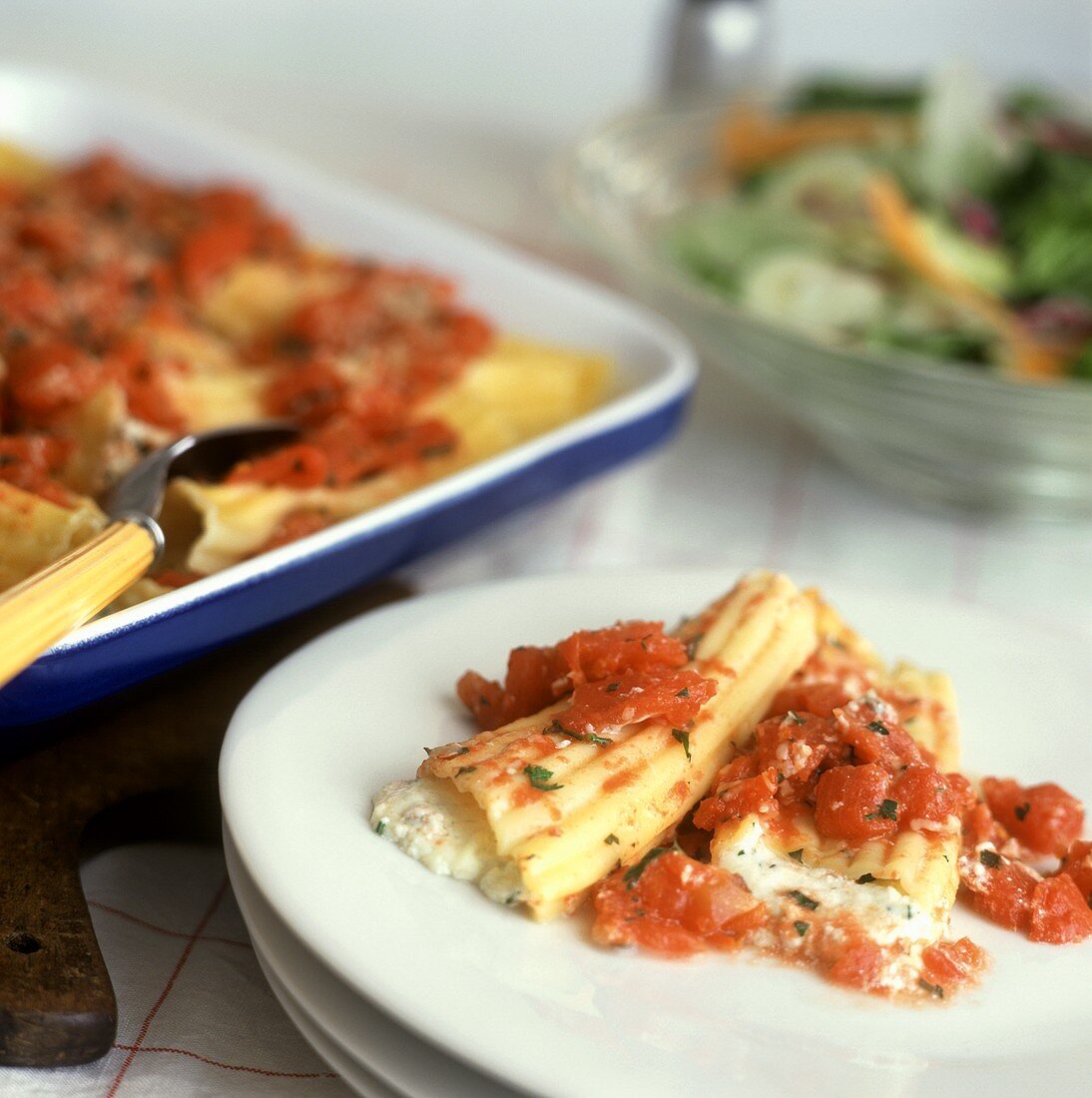 Homemade Manicotti on a Plate and in a Baking Dish