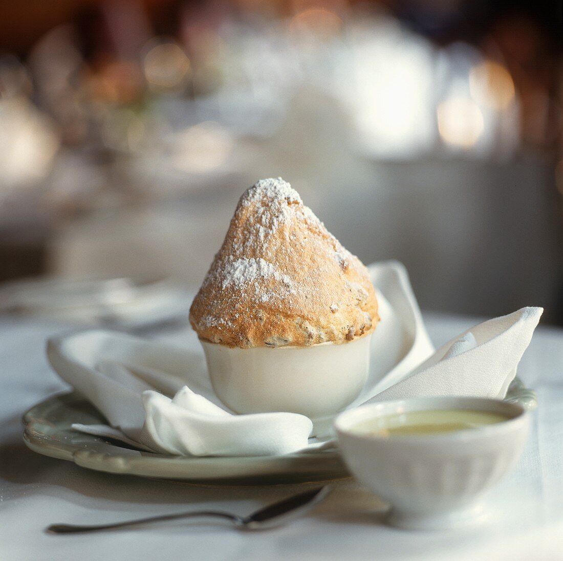 Small soufflé with icing sugar and custard