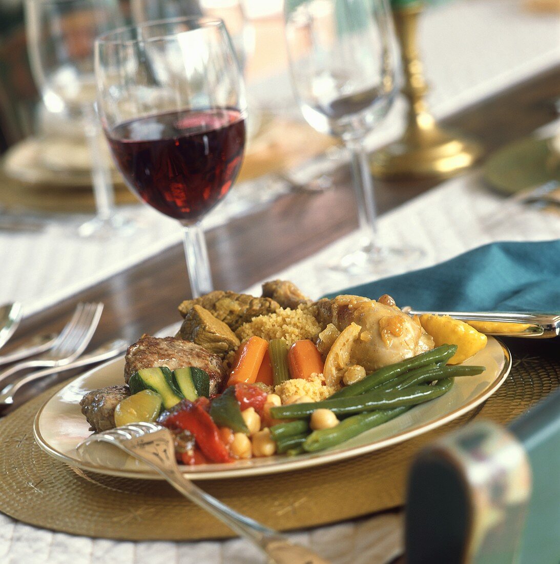 Chicken with stuffing and vegetables, glass of red wine