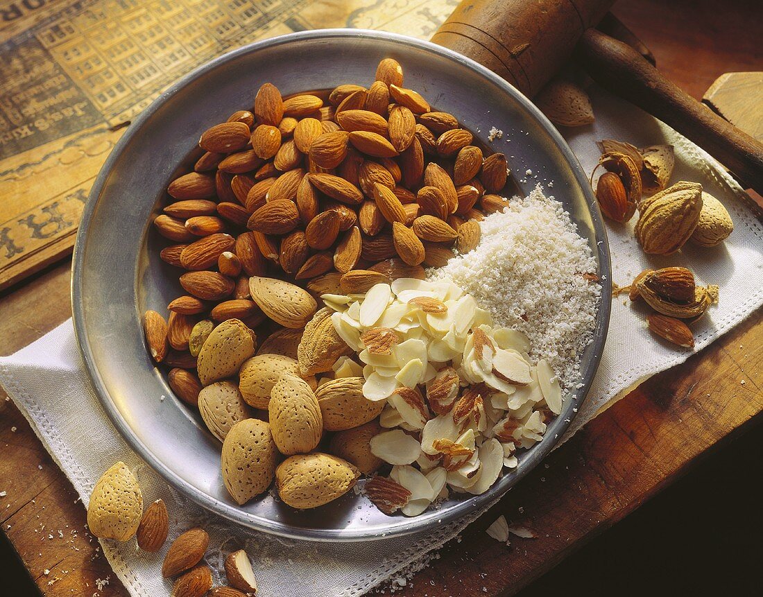 Shelled Whole Flaked and Ground Almonds on a Plate