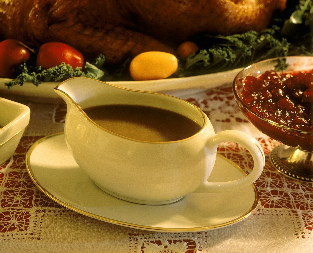 Brown sauce in sauce boat & cranberry sauce for roast turkey