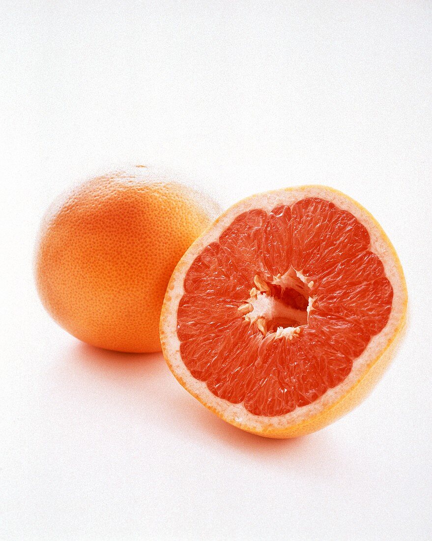 A Whole Grapefruit with a Half of a Grapefruit