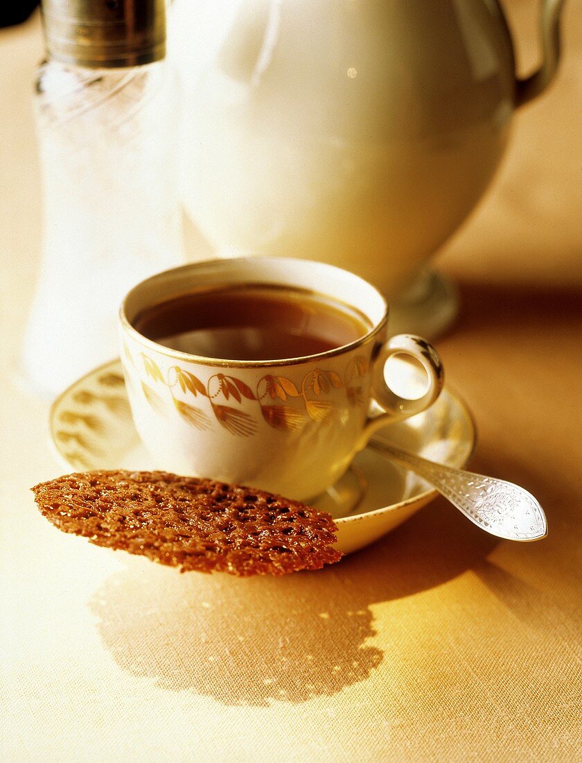 Cup of Hot Tea with a Thin Chocolate Cookie