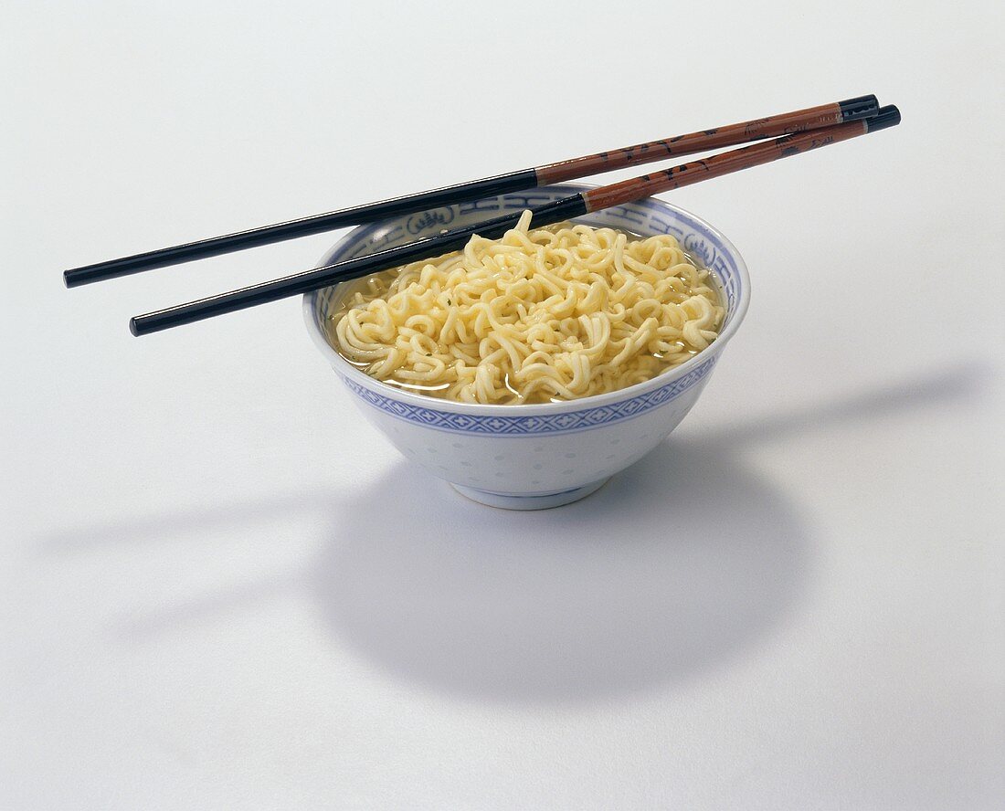 A Bowl of Ramen Noodles with Chop Sticks