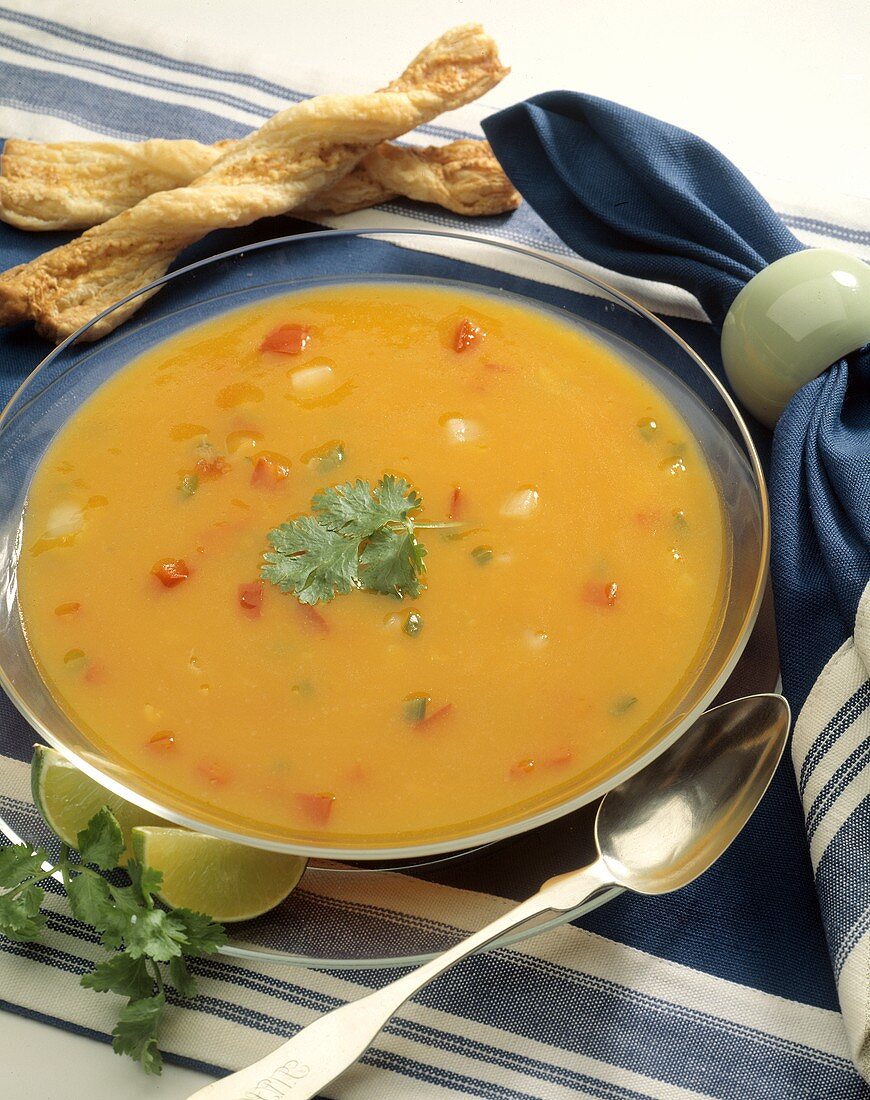 A Bowl of Corn Soup with Bread Sticks