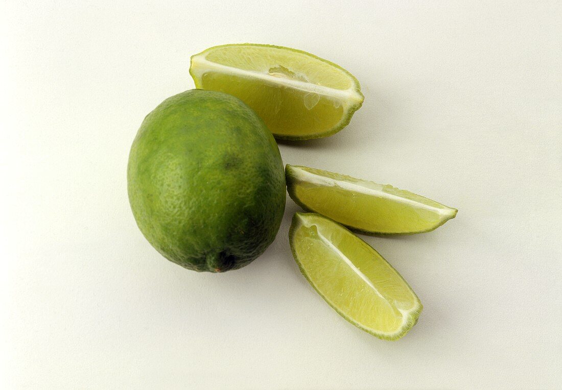 A Whole Key Lime with Three Lime Wedges