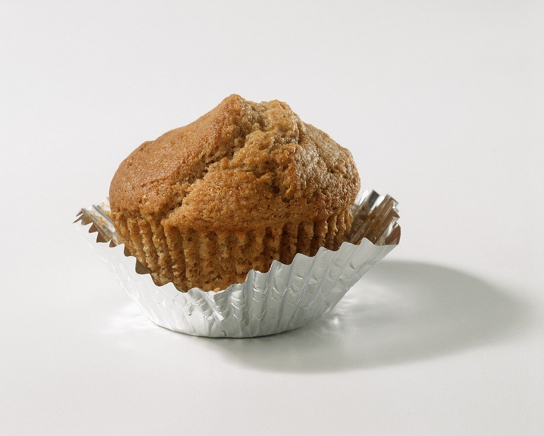 A bran muffin in a case