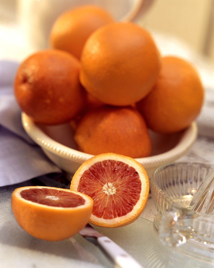 A Blood Orange Cut in Half; A Bowl of Oranges