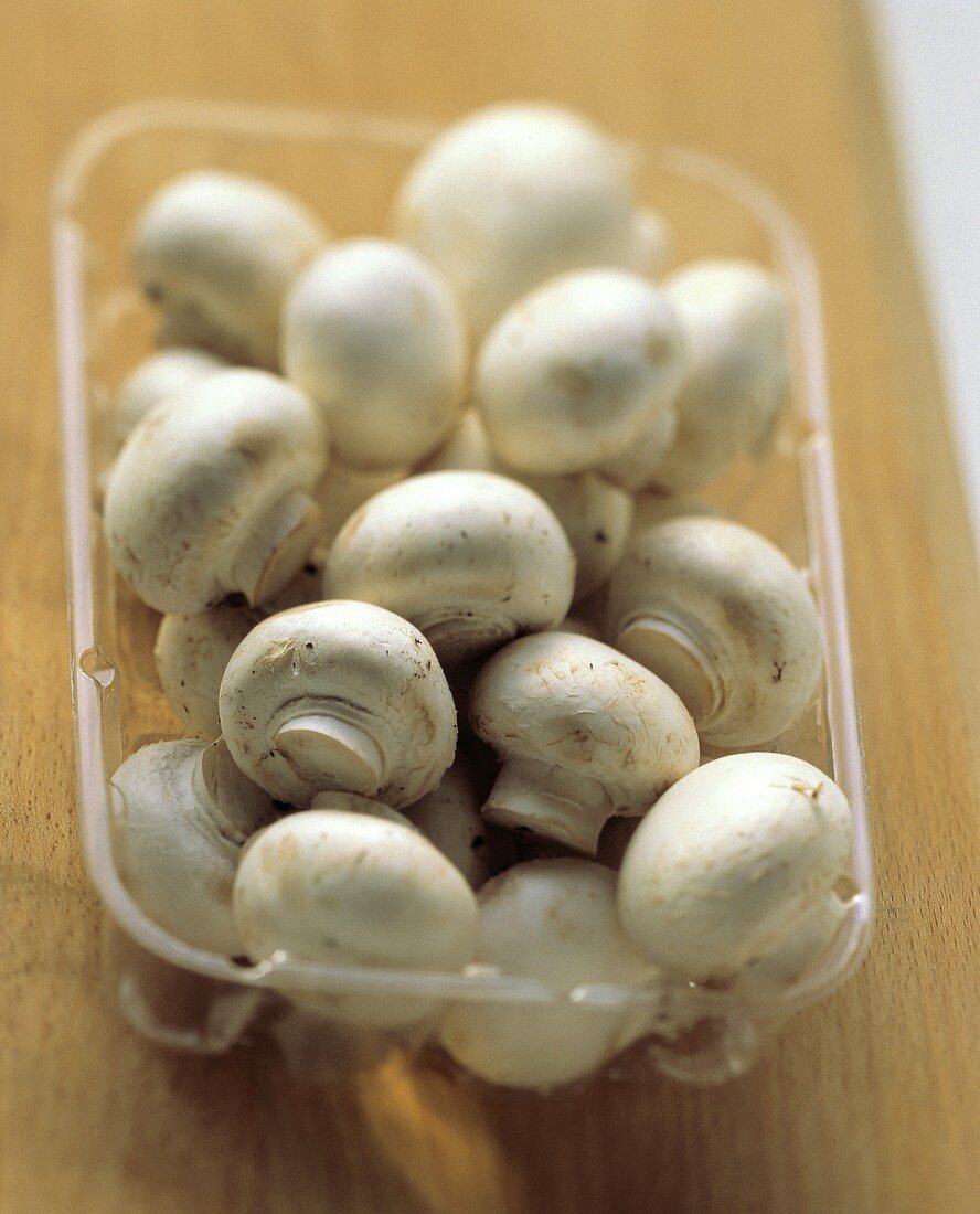 White Button Mushrooms in a Plastic Container