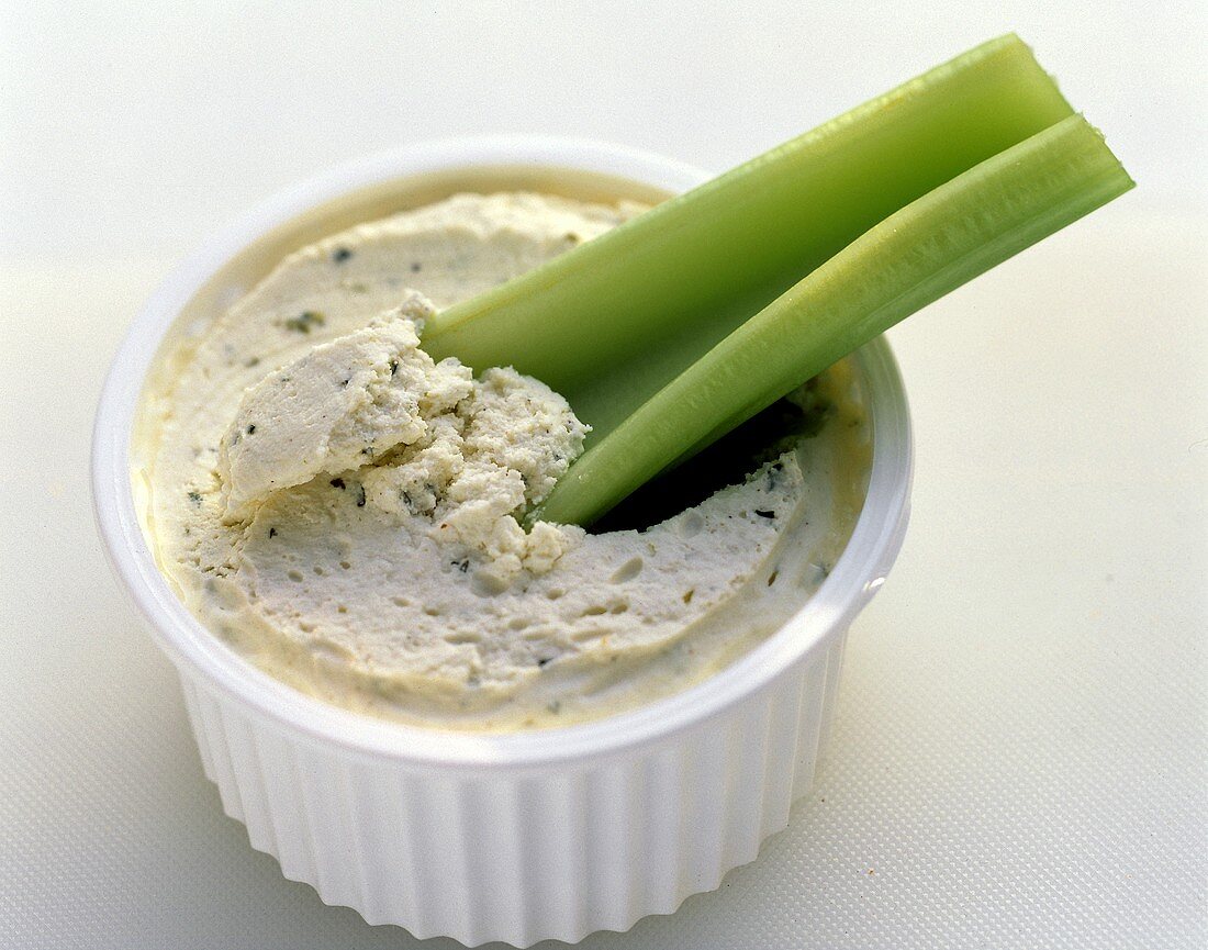 A Celery Stick in a Bowl of Vegetable Dip