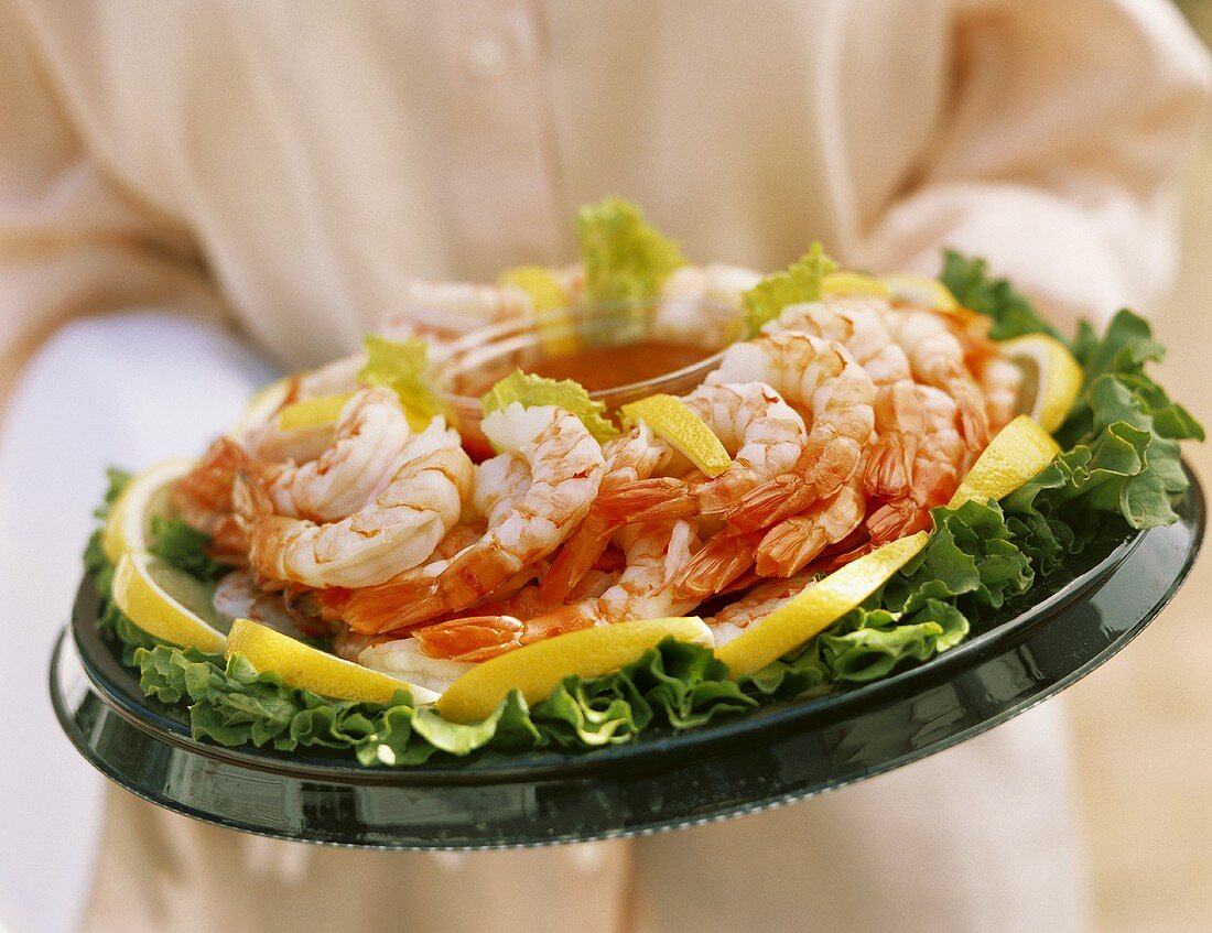 Person Holding a Shrimp Platter