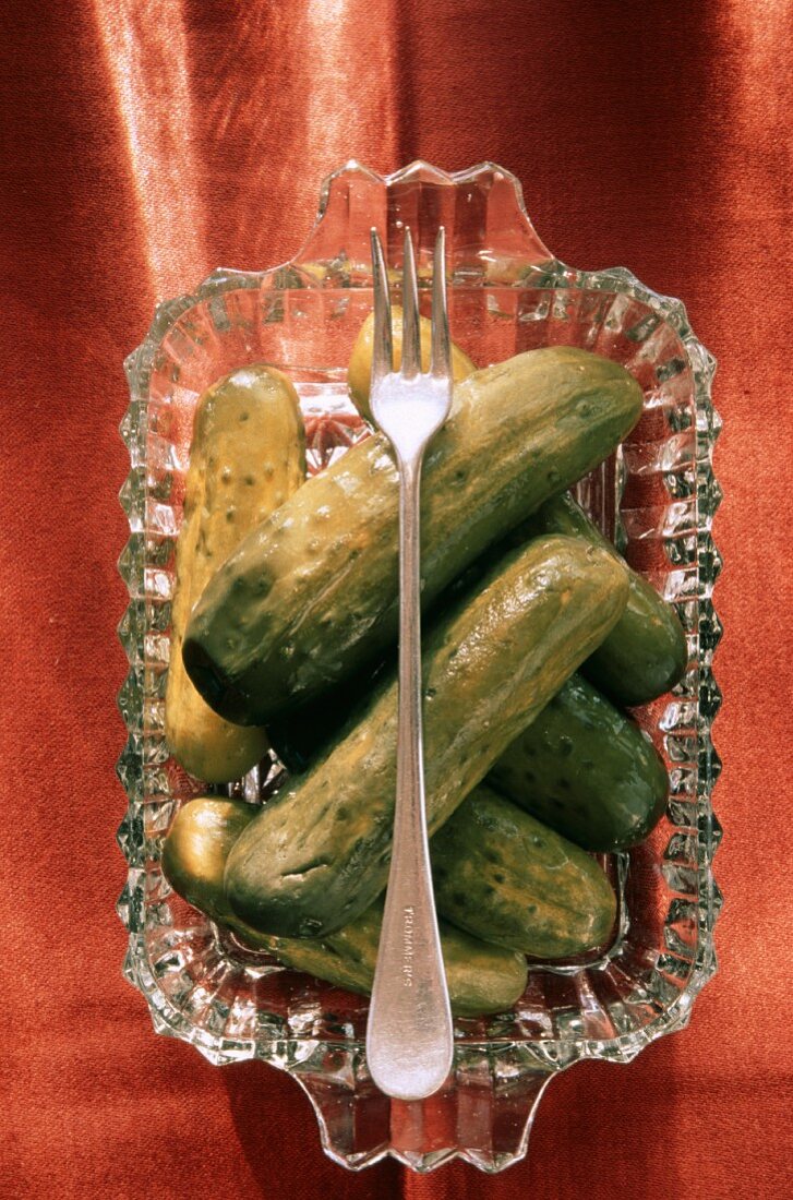 A Glass Dish With Pickles; Fork