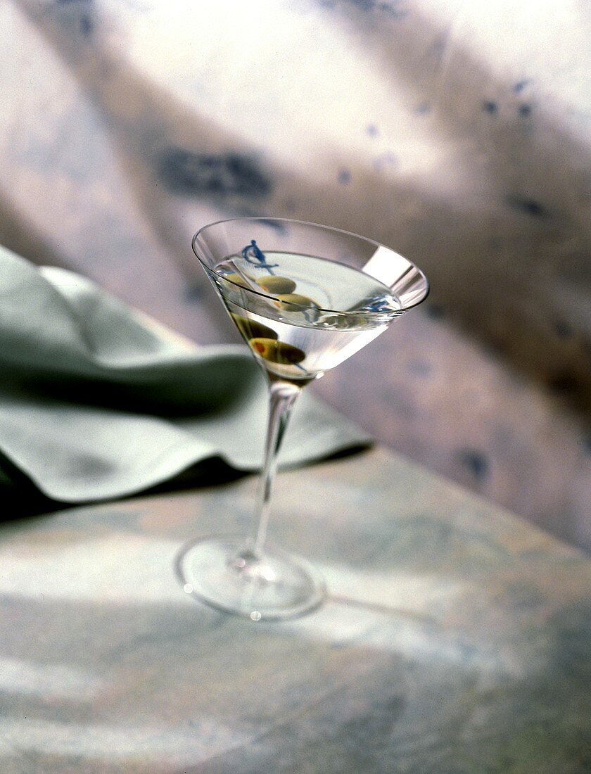 A Single Martini with Green Olives