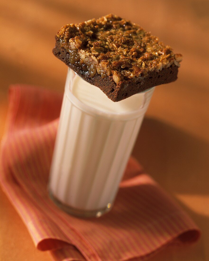 Brownie with Nut Topping on a Glass of Milk