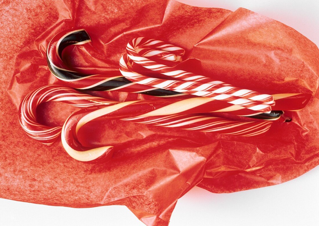 Assorted Candy Canes on Red Tissue Paper