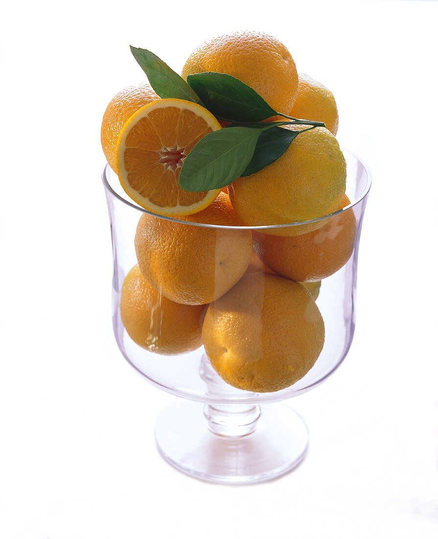 Many Oranges in a Tall Glass Bowl