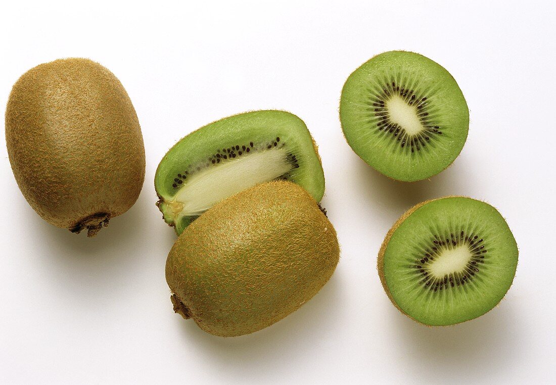 Whole and halved kiwi fruit