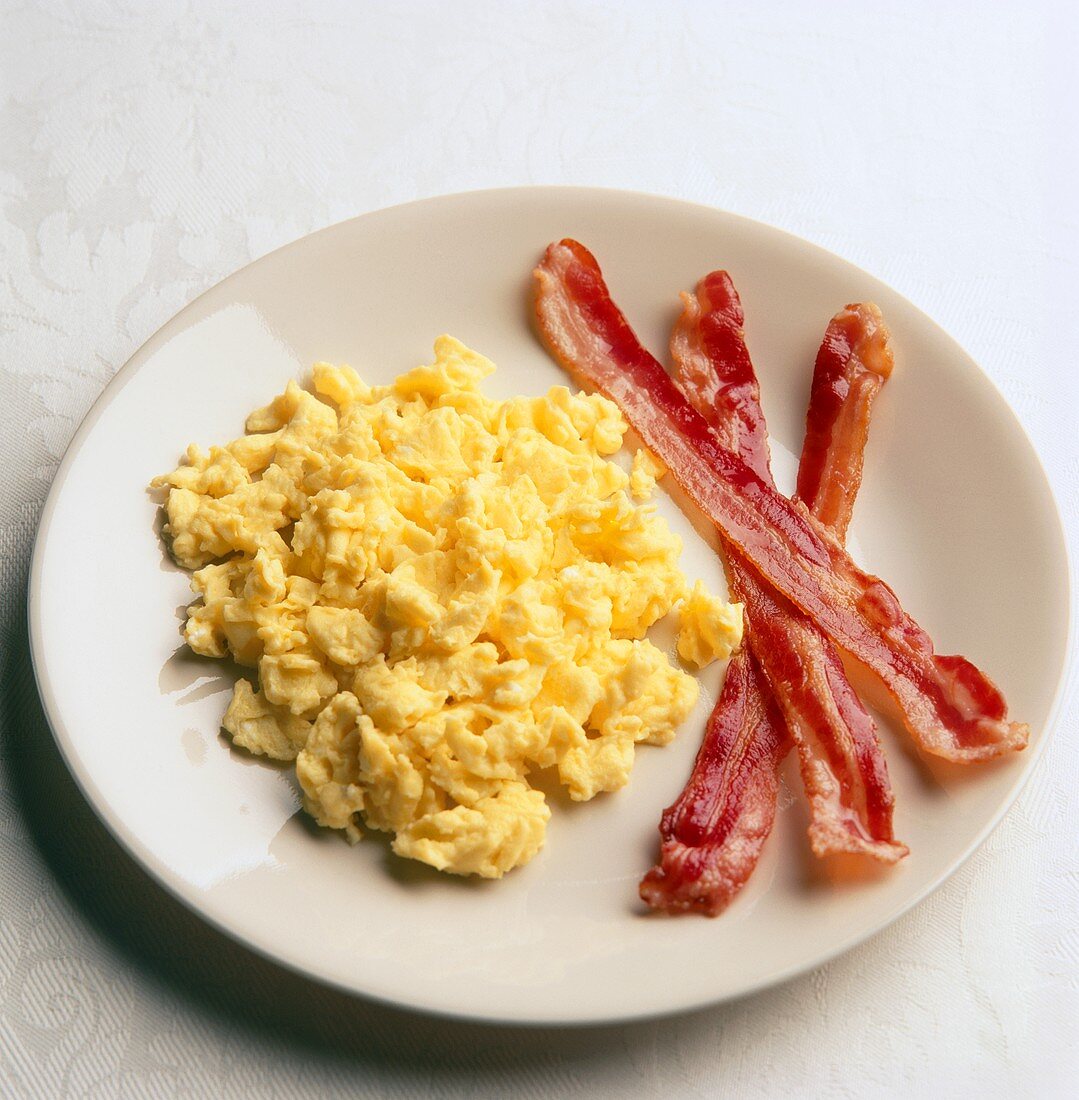 Scrambled Eggs and Bacon on a White Plate