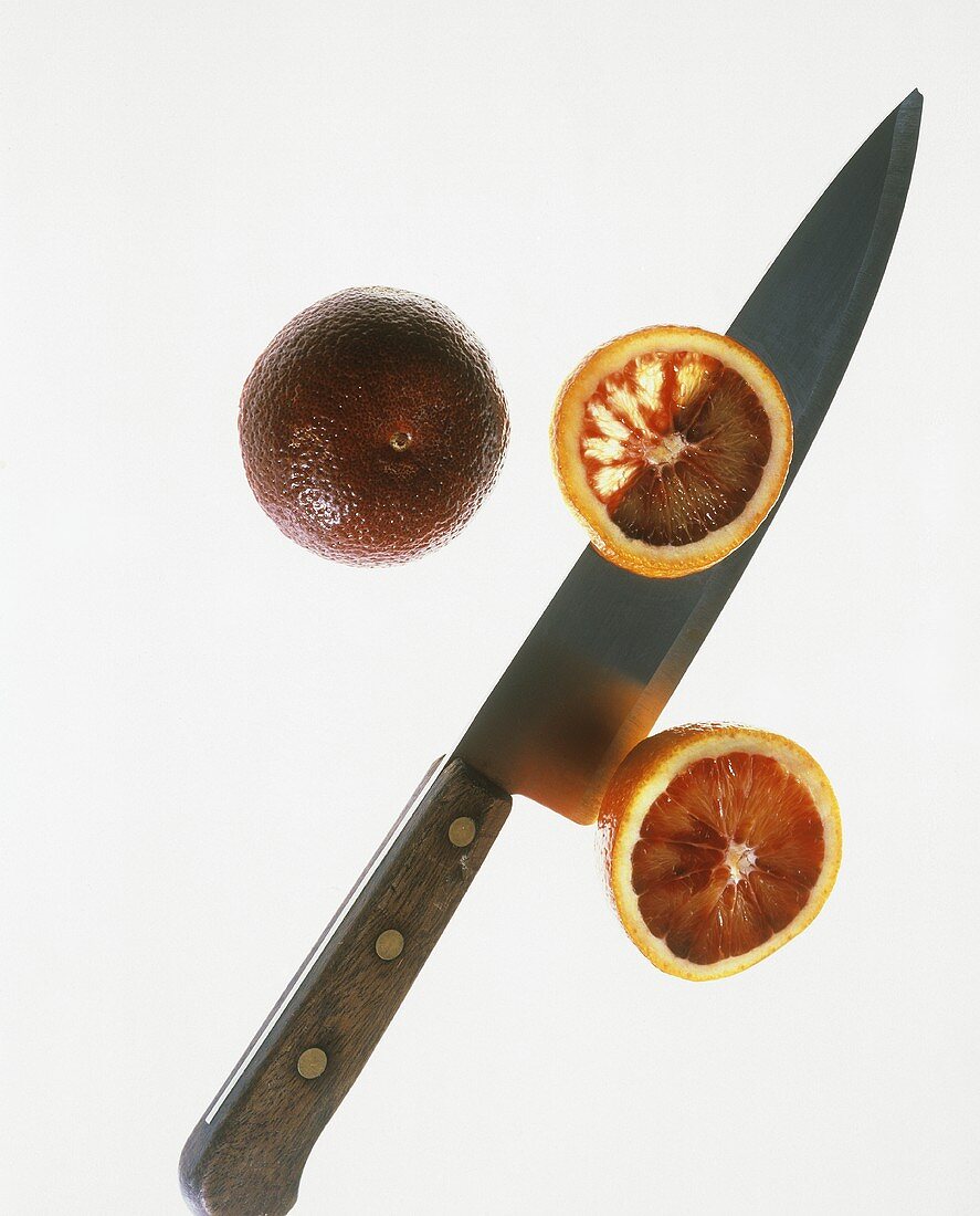 Two Blood Oranges; One Sliced Open; Knife