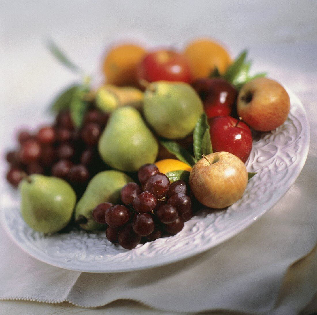 Verschiedene Obstsorten auf weisser Platte