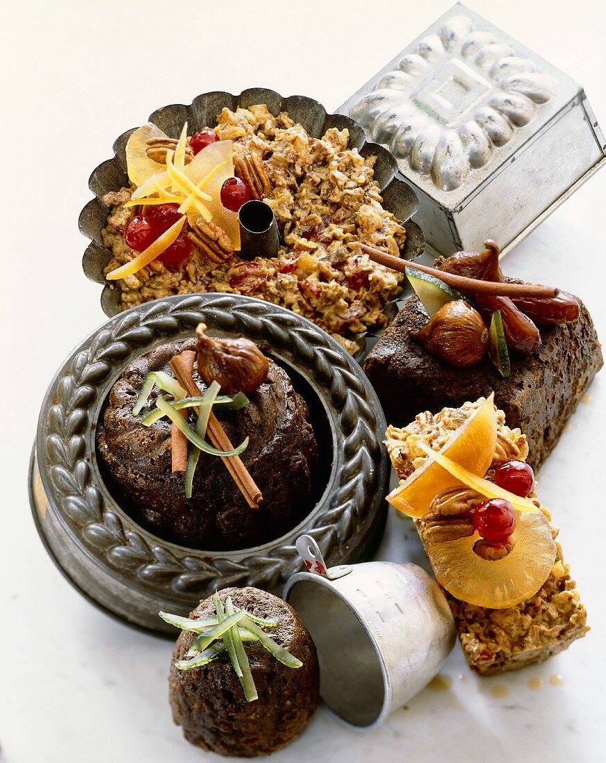 Various Fruit Cakes and Pans on a White Background