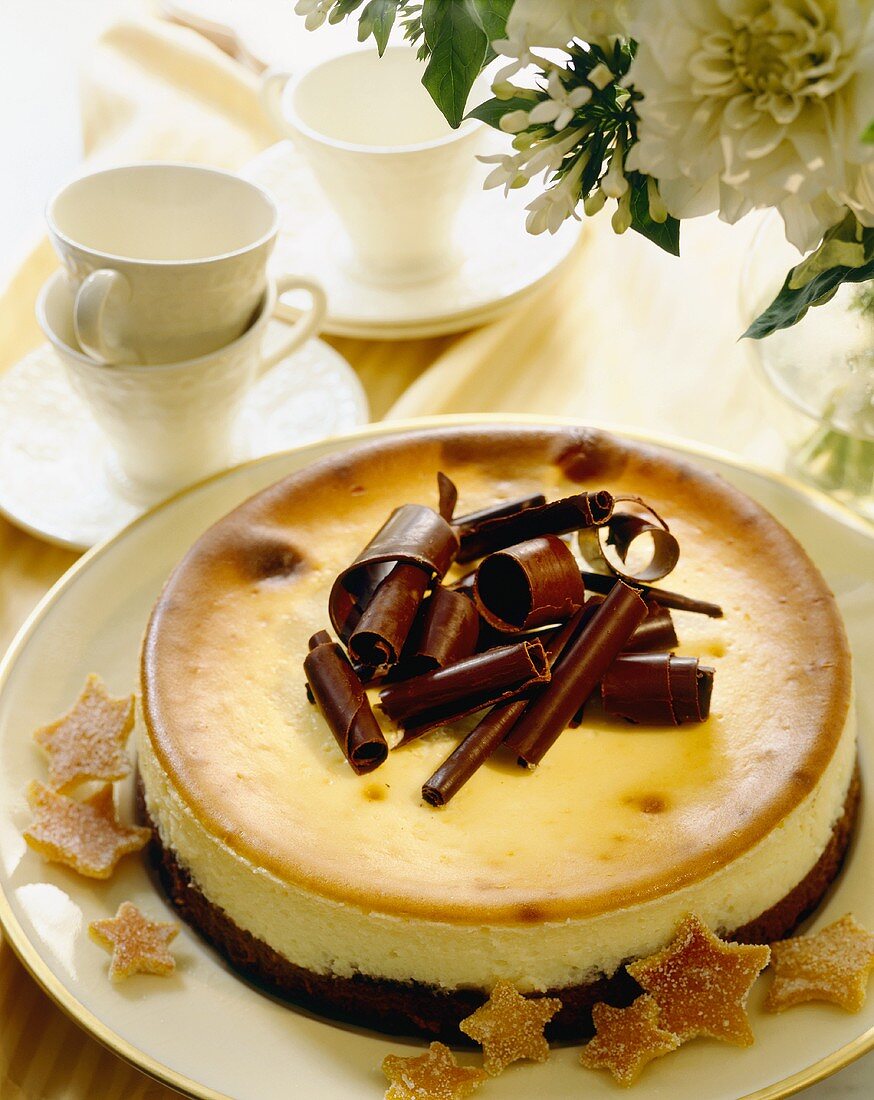 Cheesecake with Chocolate Crust Topped with Chocolate Curls; Tea Cups