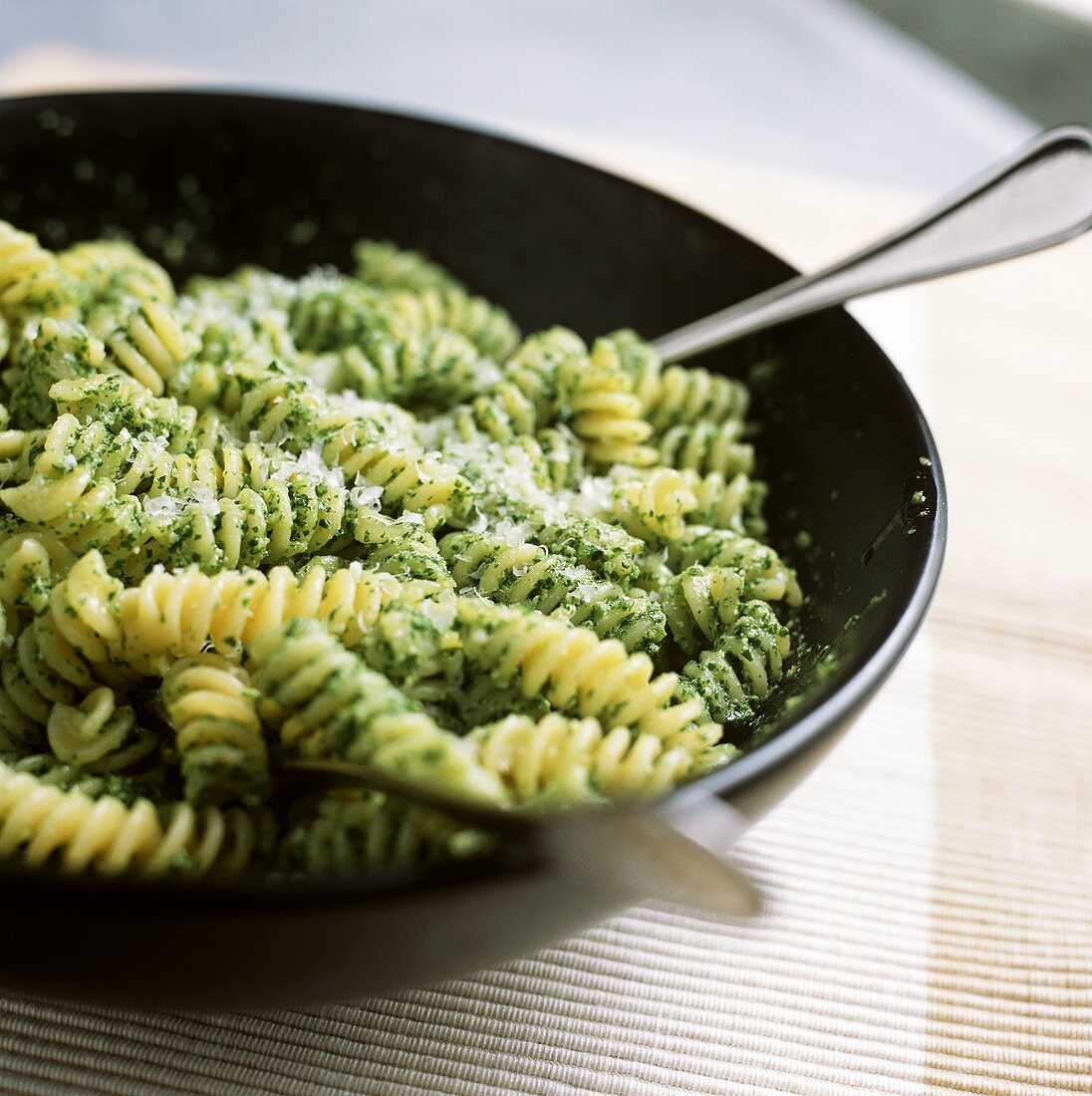 Pasta spirals with basil pesto and grated Parmesan