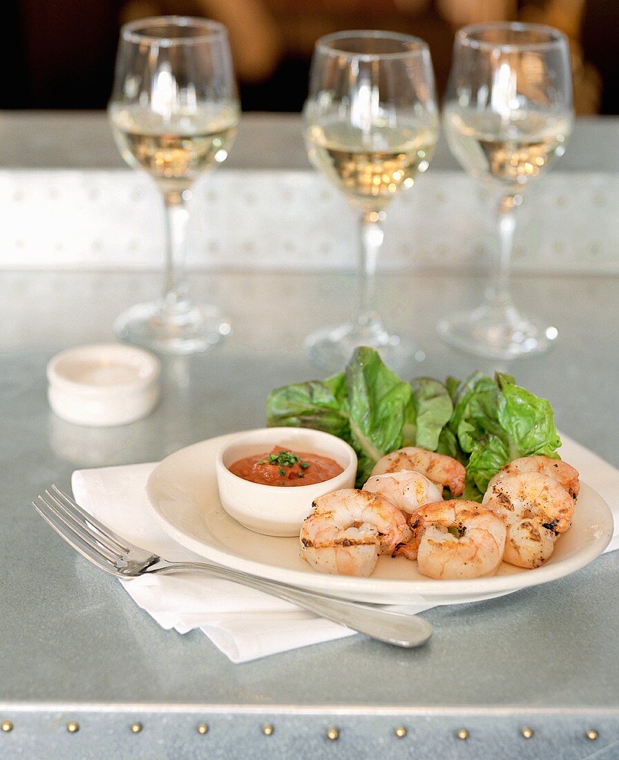 Grilled shrimps with dip & lettuce, glasses of white wine