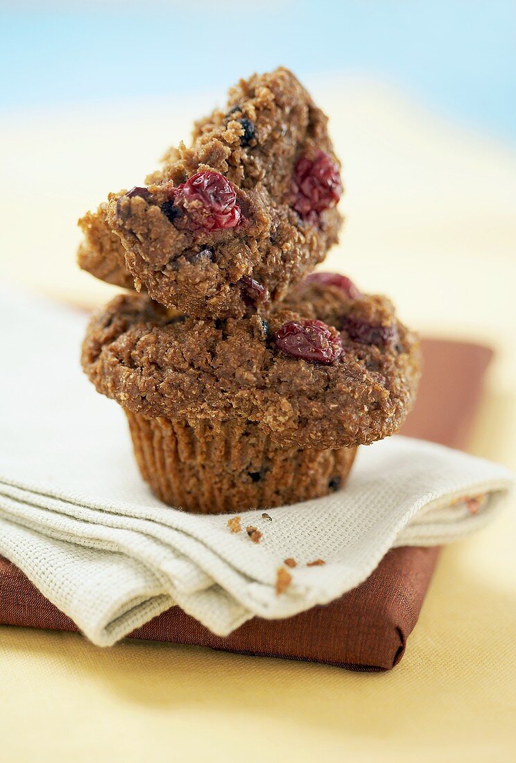 Half a cranberry bran muffin on a whole muffin
