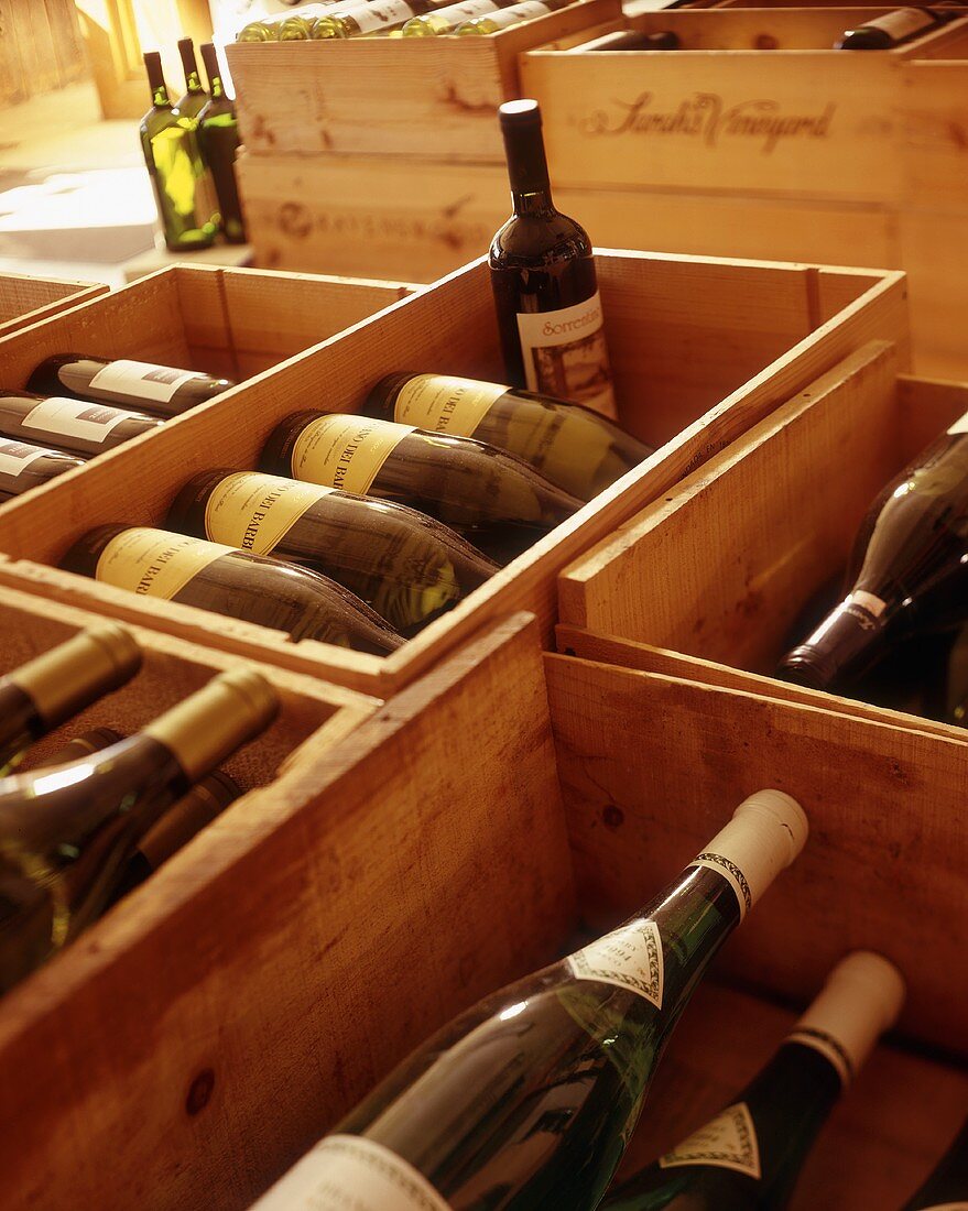 Many wine bottles in wooden boxes