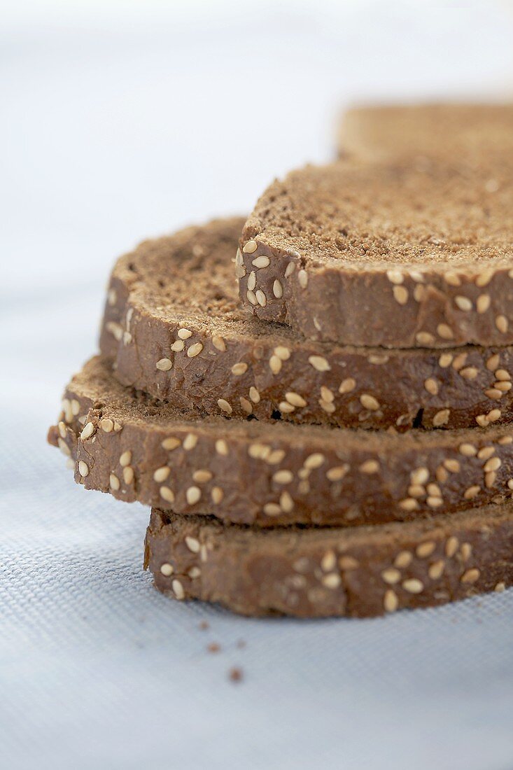 Four slices of wholemeal bread in a pile