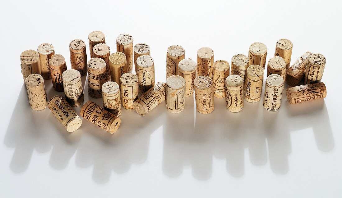 Many wine corks on white background with shadows