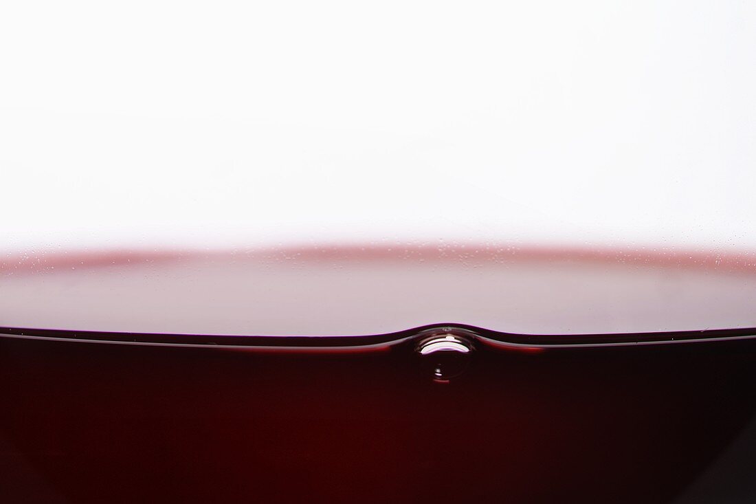Air bubble in a glass of red wine (detail)