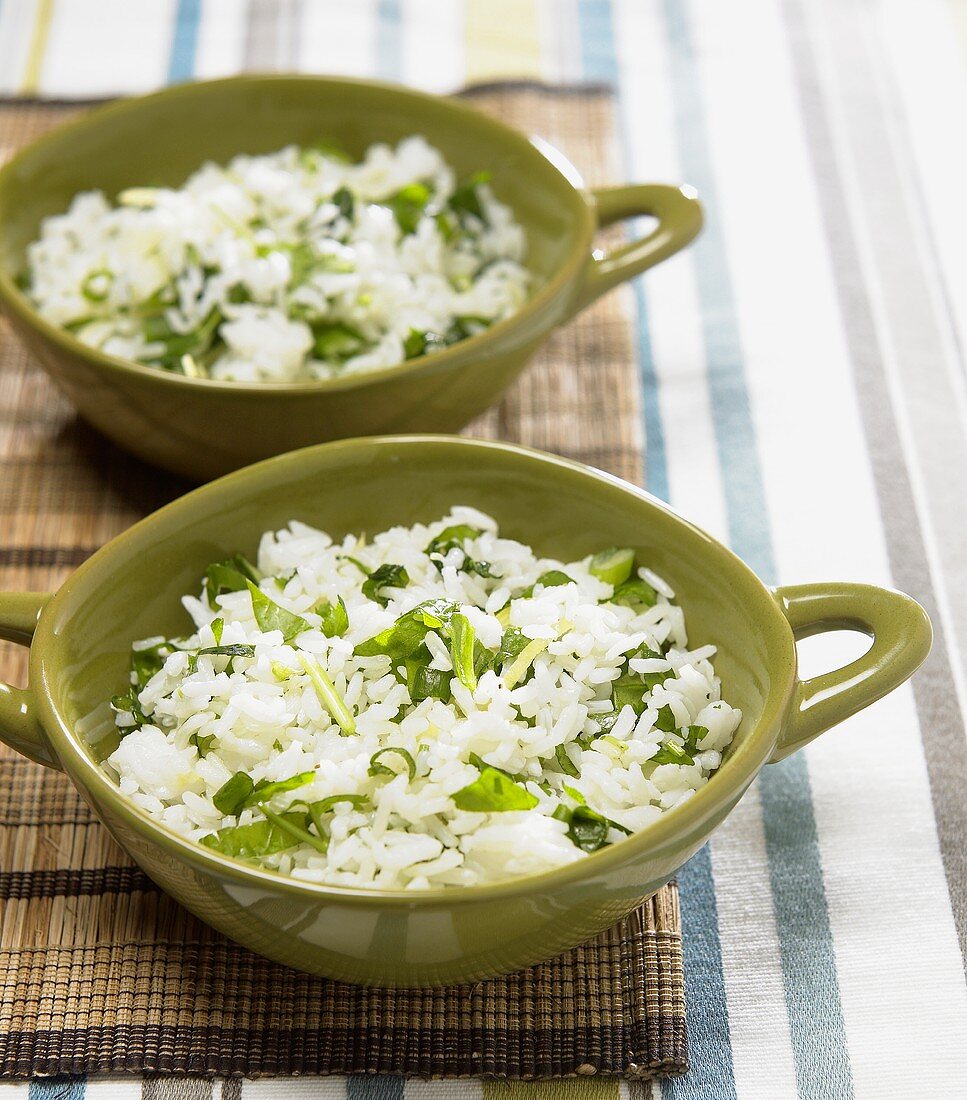 Two bowls of jasmine rice with coriander leaves