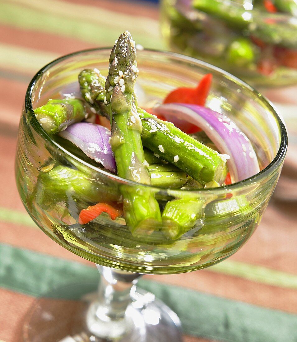 Asparagus salad with onions in glass bowl