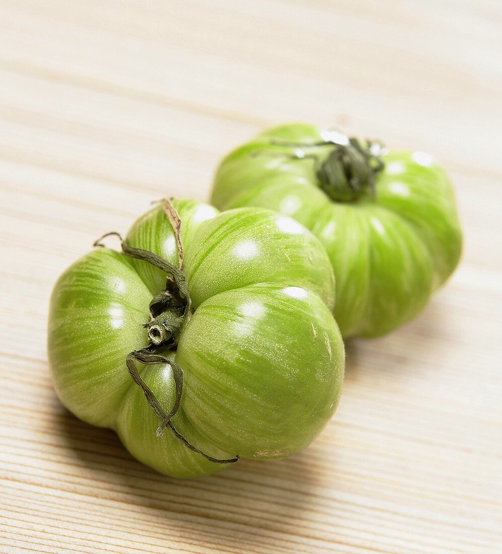 Two green heirloom tomatoes