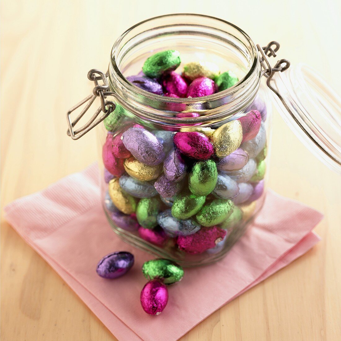Coloured chocolate Easter eggs in a storage jar