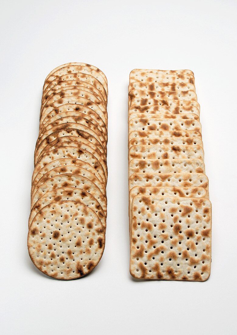 Two rows of matzoh crackers (round and square)